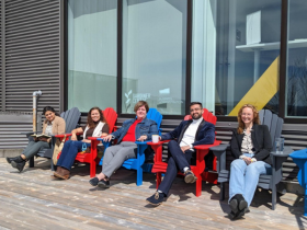Participants sitting in chairs on deck